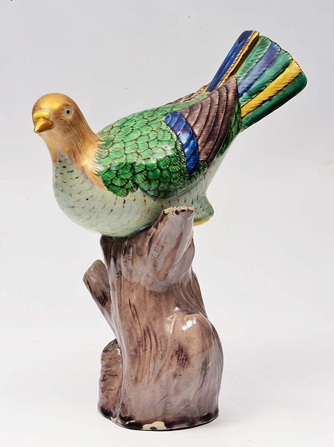 Appraisal: A CHINESE PORCELAIN MODEL OF A PIGEON on a branch