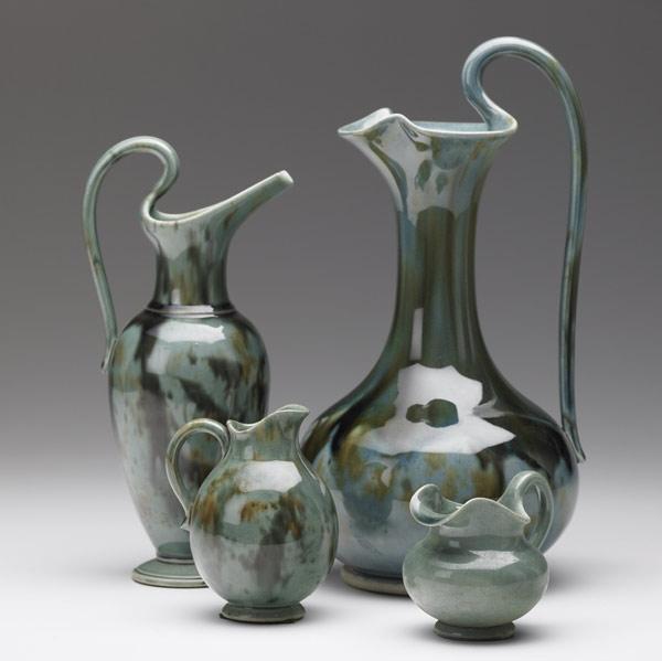 Appraisal: CHELSEA KERAMIC ART WORKS Four pitchers in green and brown