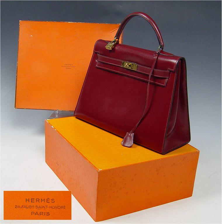 Appraisal: HERMES BURGUNDY LEATHER KELLY PURSE With lock and key sheath