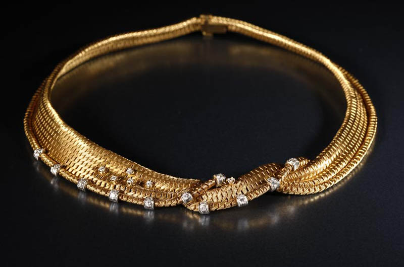 Appraisal: A gold and diamond ribbon necklace A gold and diamond