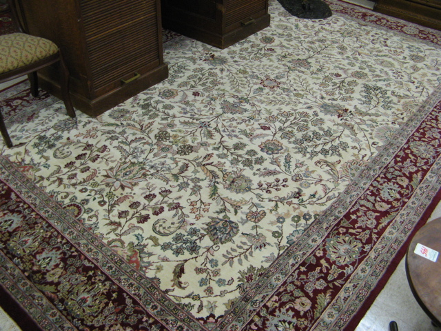 Appraisal: HAND KNOTTED ORIENTAL CARPET Indo-Persian overall floral decoration on ivory