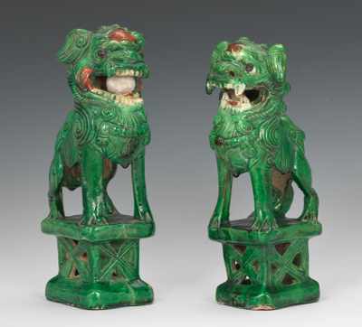 Appraisal: A Pair of Chinese Glazed Pottery Foo Dogs Fiercely poised