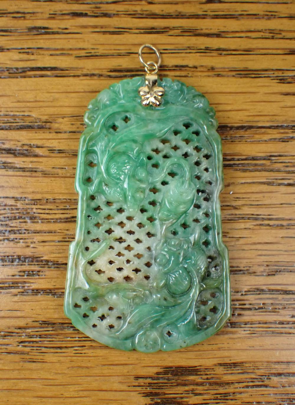 Appraisal: CHINESE JADE AND EIGHTEEN KARAT GOLD PENDANT The hand-carved green