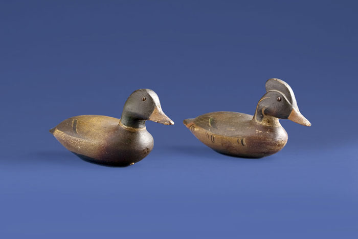 Appraisal: PAIR OF MINIATURE DUCK DECOYS IN THE STYLE OF JOHN