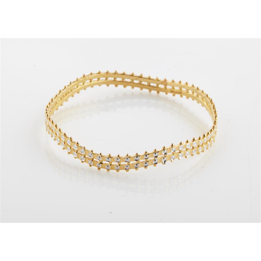 Appraisal: A yellow metal bangle of circular waved design with beaded