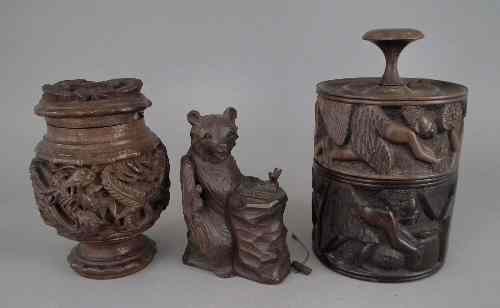 Appraisal: An African hardwood circular box and cover carved with figures