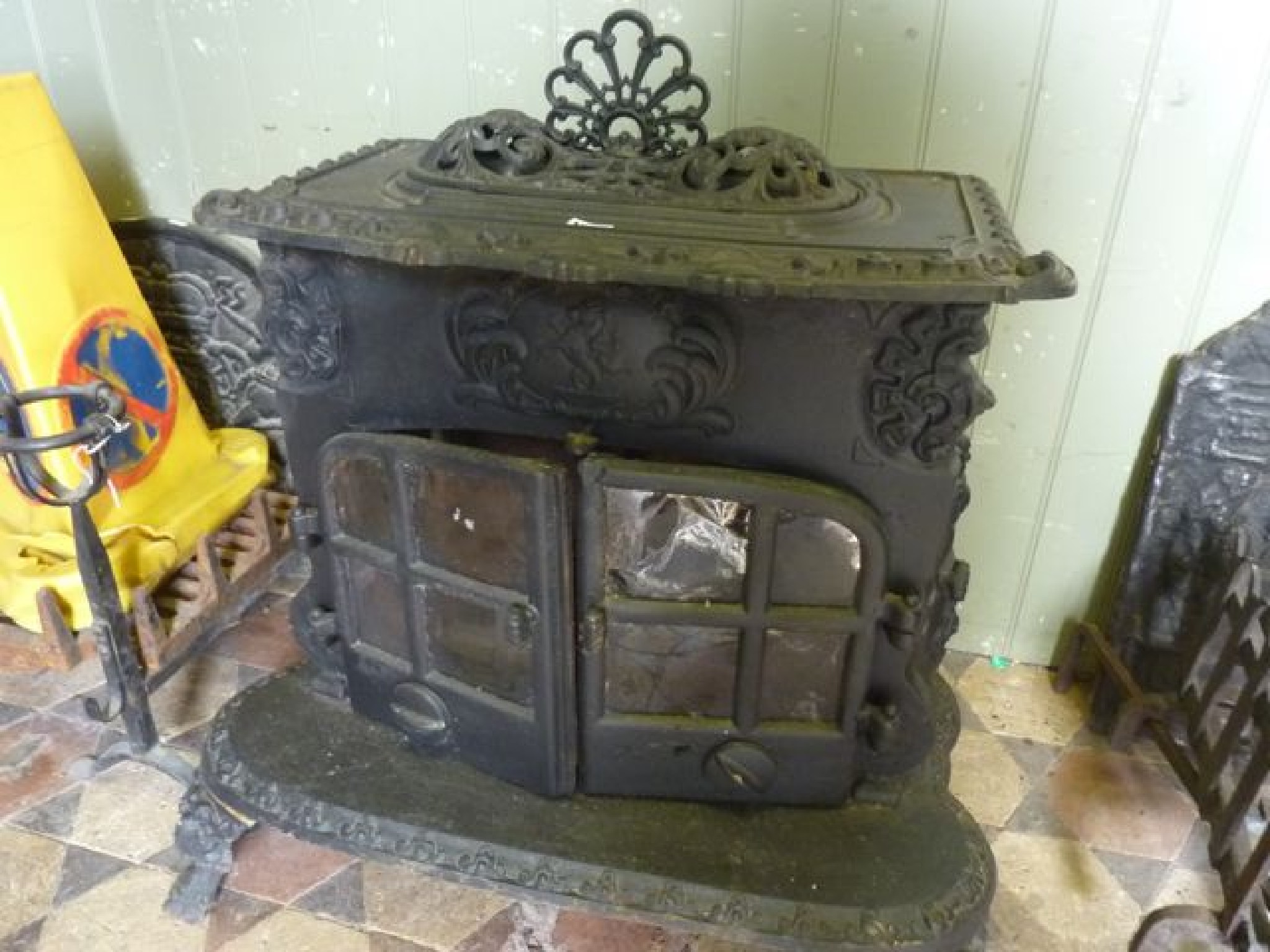 Appraisal: A substantial and decorative cast iron wood burning stove in