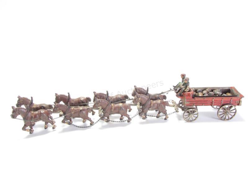 Appraisal: A Kenton-type reproduction cast iron wagon with -horse hitch wagon