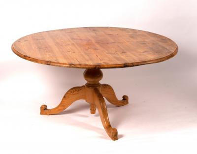 Appraisal: A circular pitch pine table on a turned column and