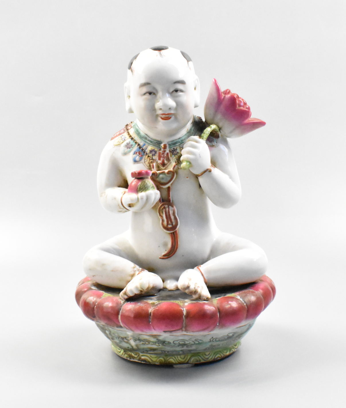 Appraisal: A Chinese porcelain boy figure on a lotus platform dating