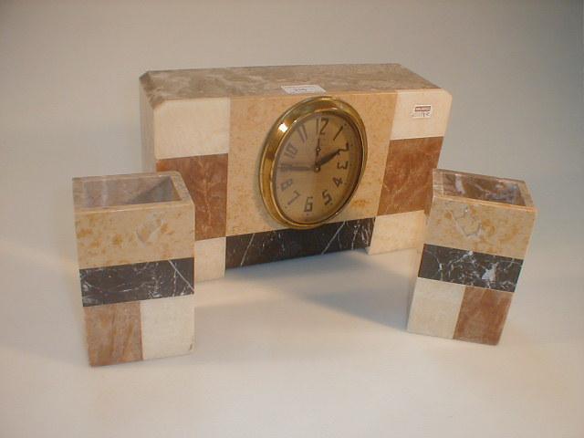 Appraisal: An Art Deco marble clock garniture the movement with a