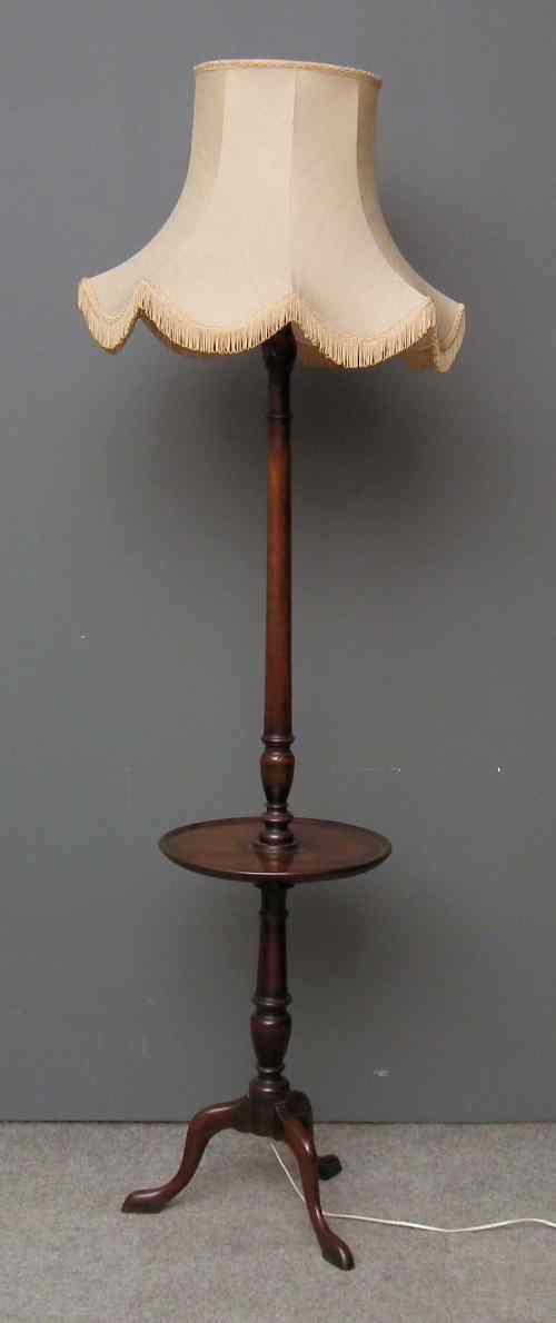 Appraisal: A mahogany standard lamp tripod table with turned centre column