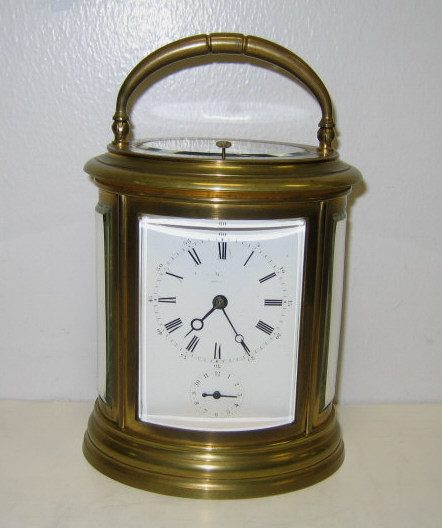 Appraisal: OVAL GILT BRASS CASE CARRIAGE CLOCK Plain case with beveled