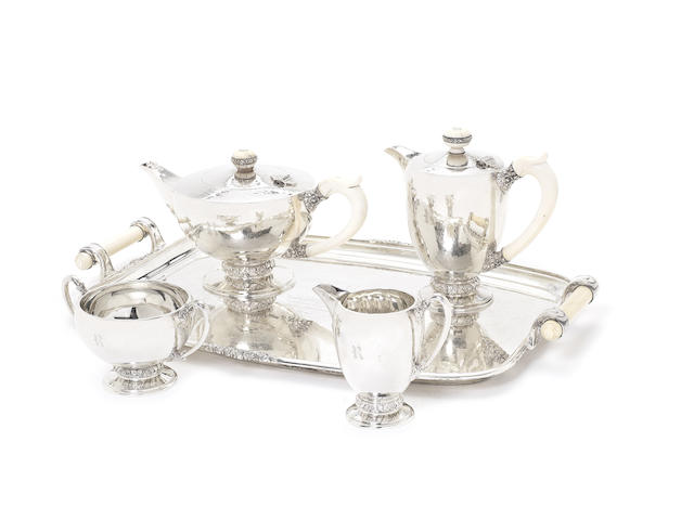 Appraisal: A silver four-piece tea service together with a two-handle tray