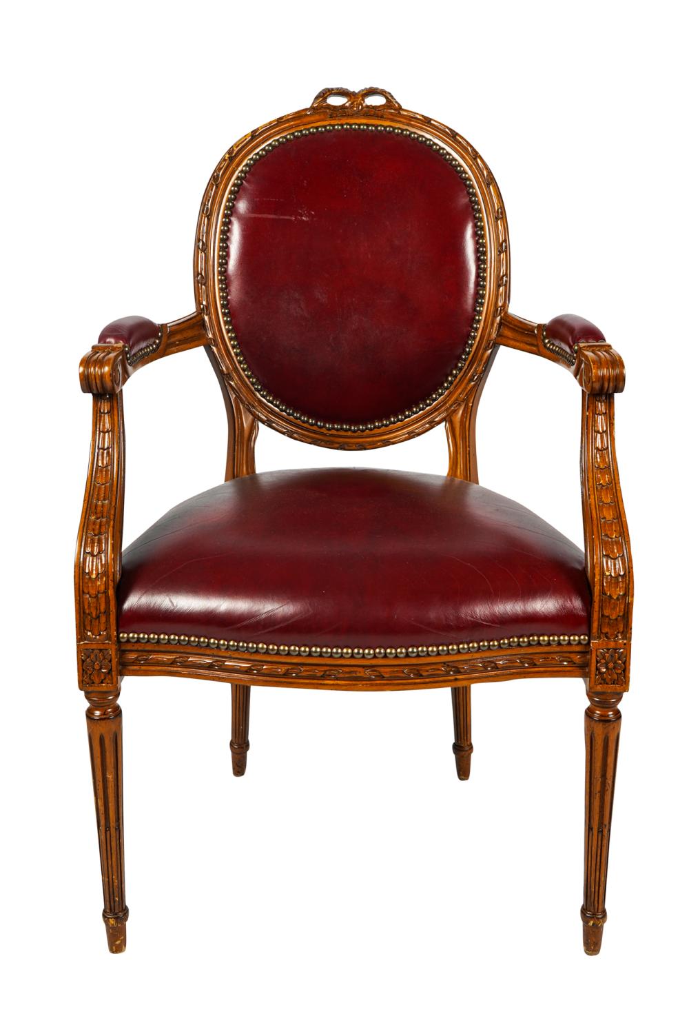 Appraisal: LOUIS XVI STYLE CARVED WALNUT FAUTEUILwith burgundy faux-leather upholstery Condition