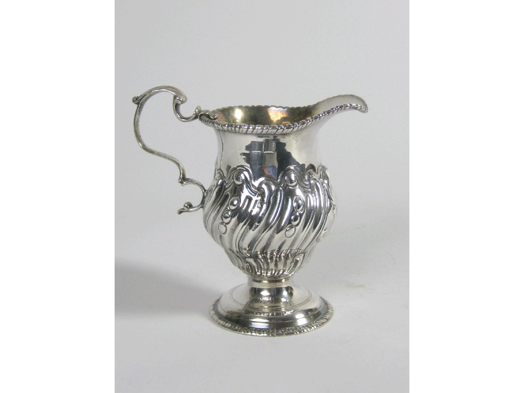 Appraisal: A George III Cream Jug of helmet shape spirally fluted