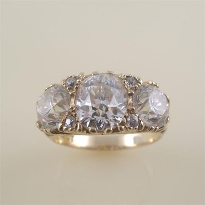 Appraisal: A substantial diamond three stone ring the oval shaped diamond