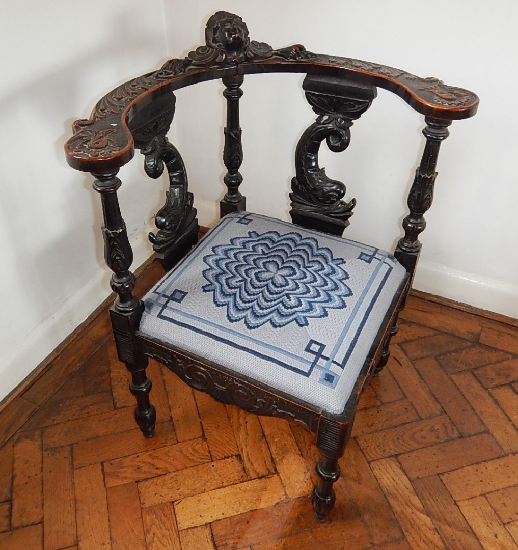 Appraisal: A Victorian carved oak corner chair with mask head to