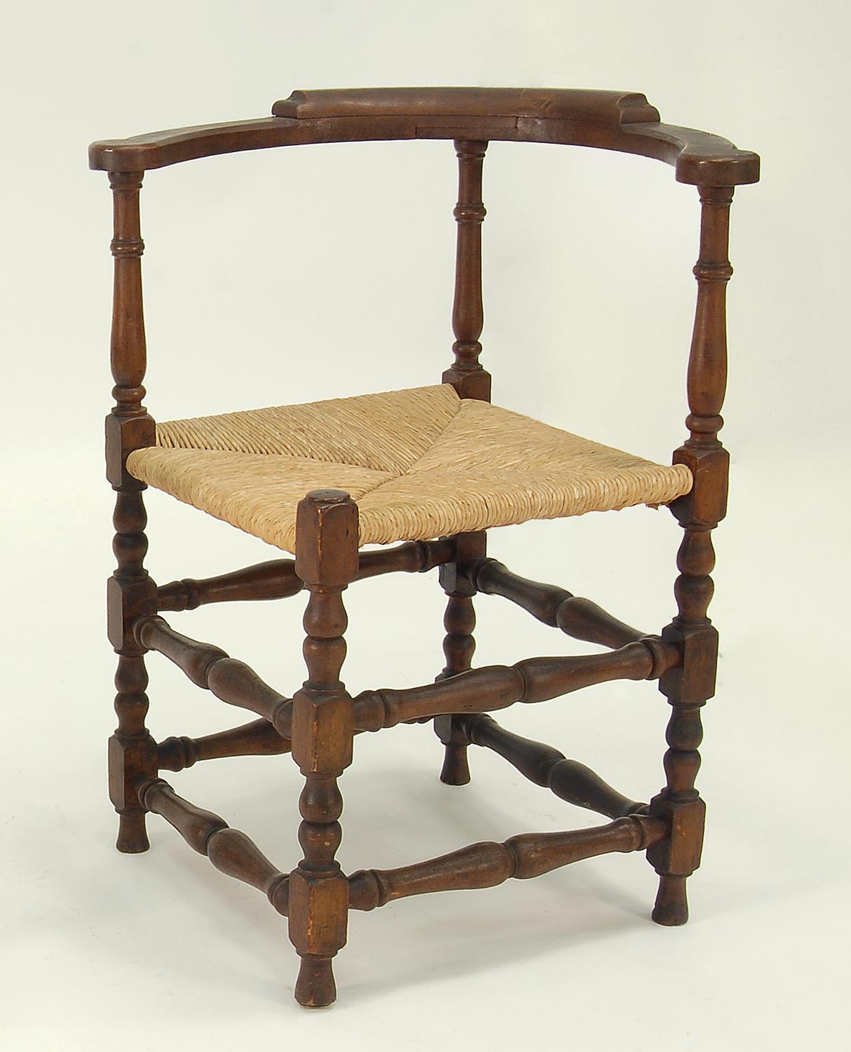 Appraisal: TH CENTURY CORNER CHAIR in walnut Eight turned stretchers Modern