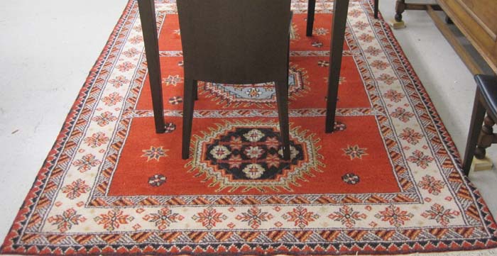 Appraisal: HAND KNOTTED ORIENTAL CARPET Indo-Kazak featuring three geometric medallions each