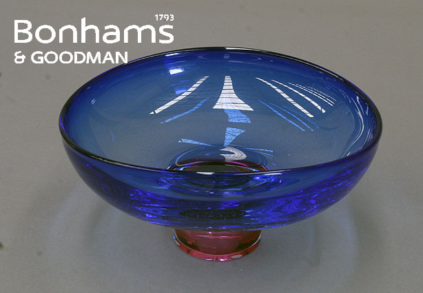 Appraisal: A Kosta blue glass bowl on canberry foot