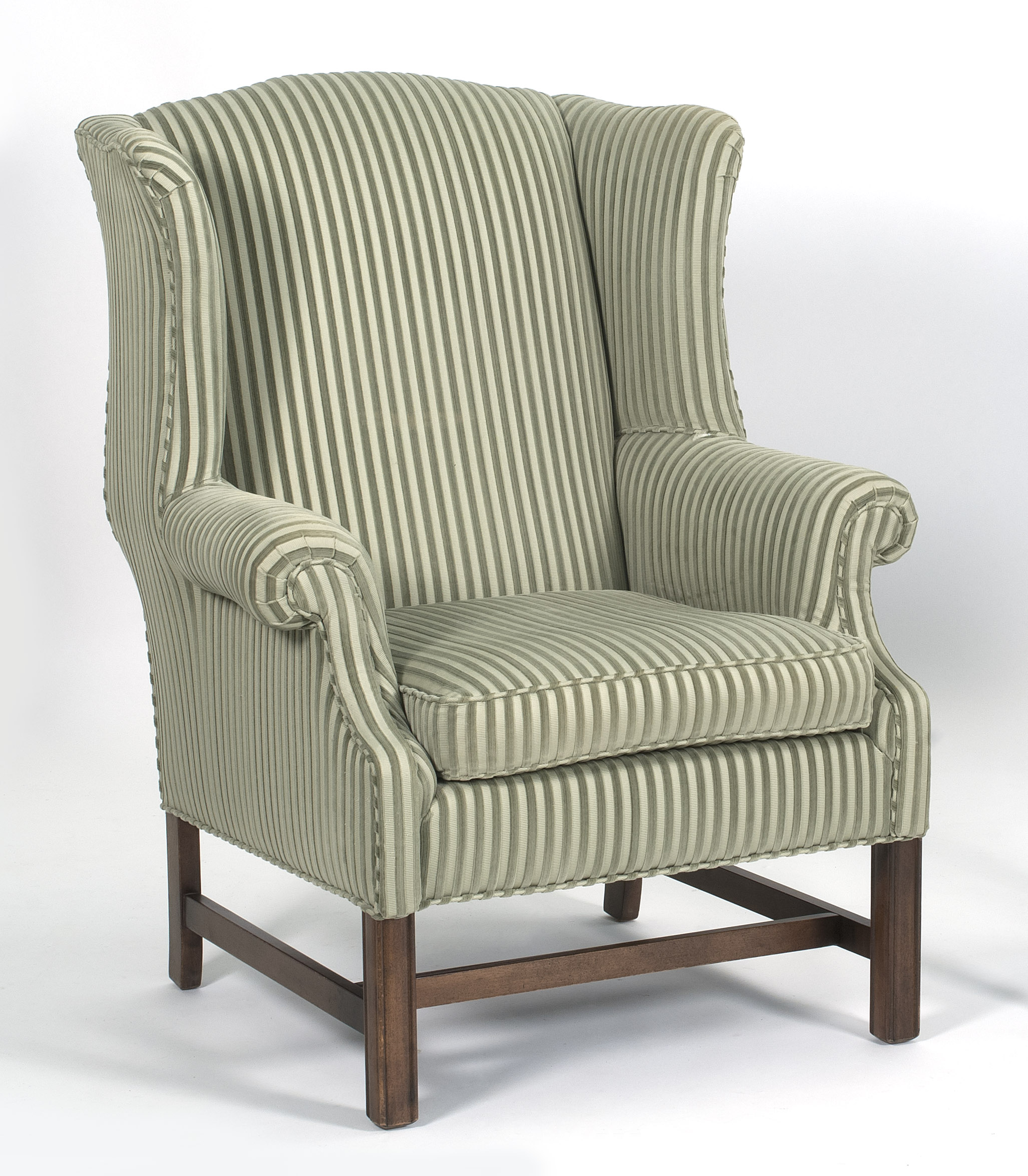 Appraisal: CHIPPENDALE-STYLE WING CHAIR in a green striped upholstery Mahogany block-molded