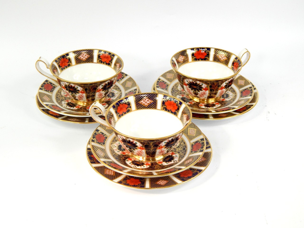 Appraisal: A set of three Royal Crown Derby porcelain trios decorated