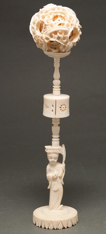 Appraisal: Japanese carved ivory puzzle ball with elaborate figural-form pedestal base