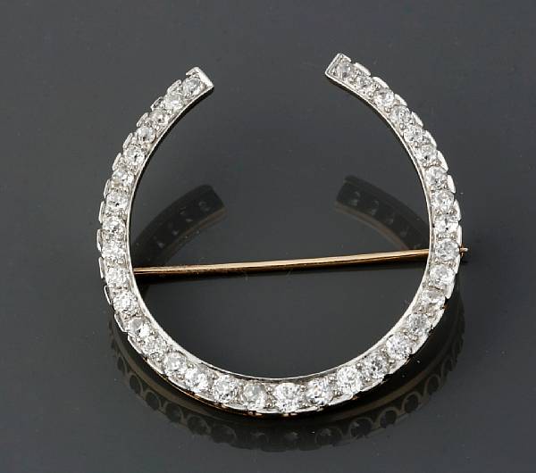 Appraisal: A diamond and k two-tone gold horseshoe brooch estimated total