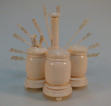 Appraisal: An ivory cruet set with accompanying cocktail sticks