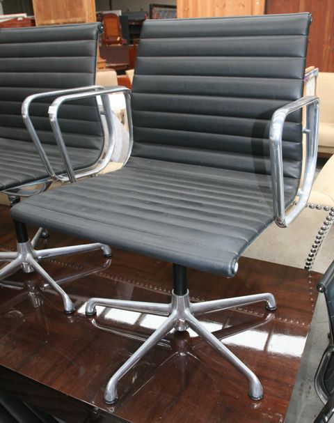 Appraisal: A pair of Charles Eames aluminium series armchairs upholstered in