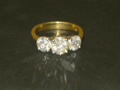 Appraisal: A THREE STONE DIAMOND RING the brilliant cup stones approximately