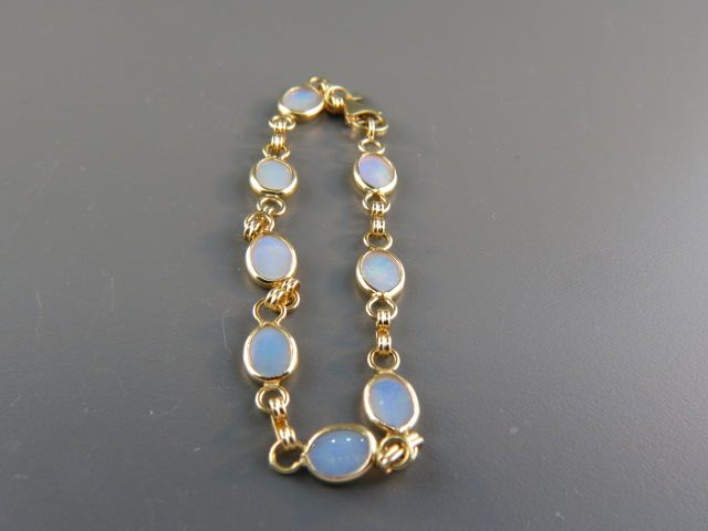 Appraisal: Opal Bracelet eight fiery gems in k yellow gold signed