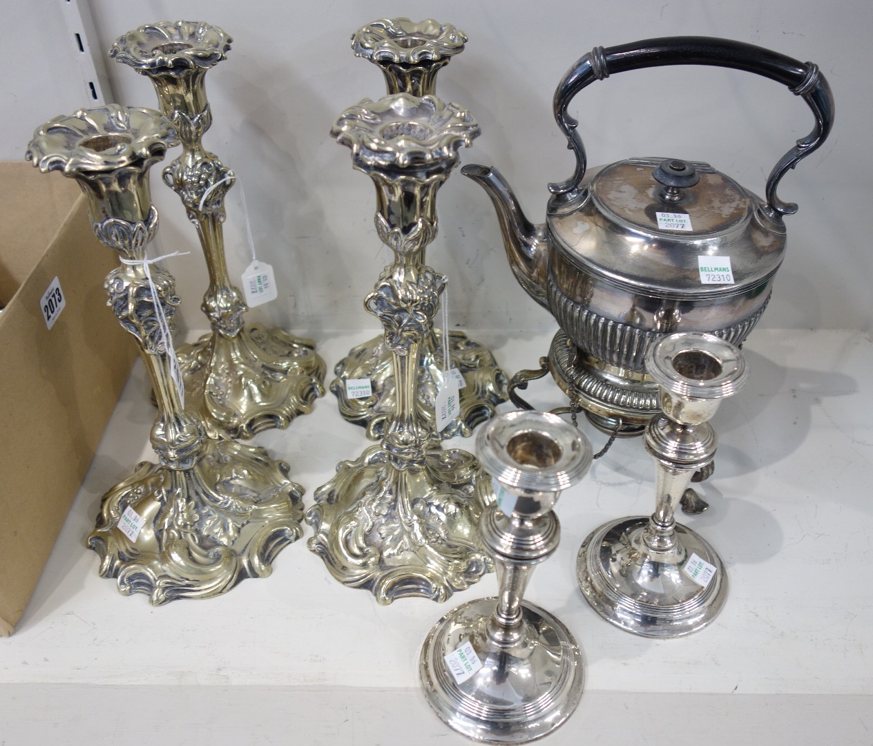 Appraisal: A set of four plated table candlesticks each with scroll