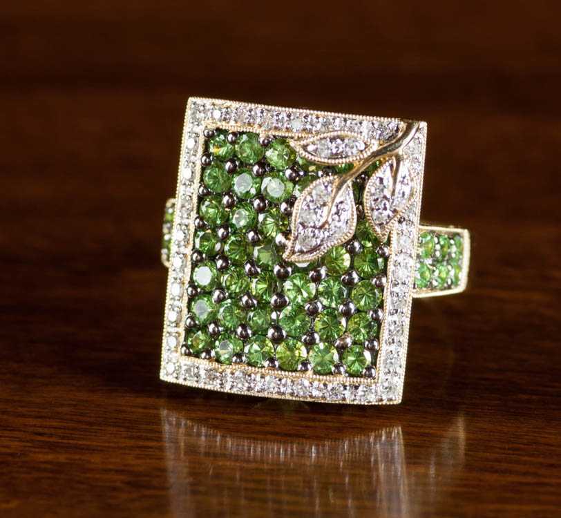 Appraisal: TSAVORITE DIAMOND AND FOURTEEN KARAT GOLD RING set with round-cut