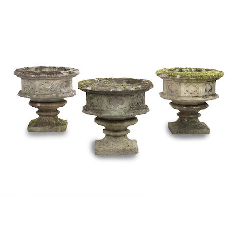 Appraisal: Three composition garden urns Each octagonal bowl decorated with quaterfoil