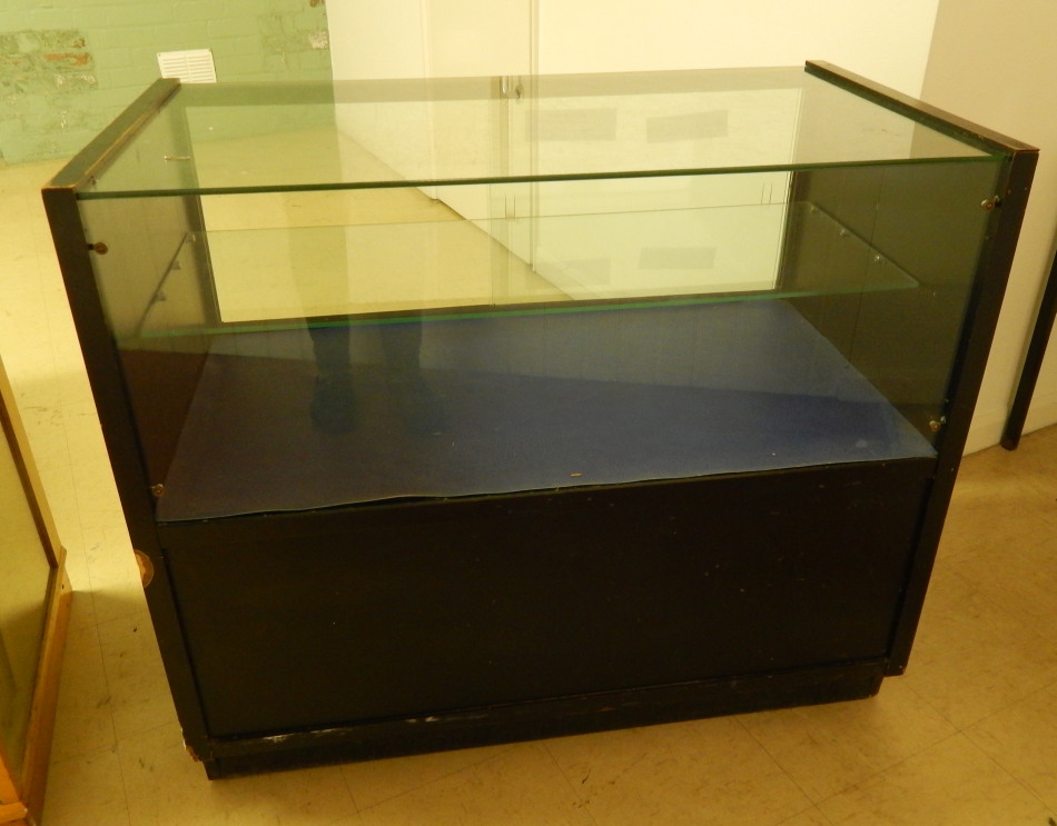 Appraisal: A thC ebonised shop counter with a glazed top a