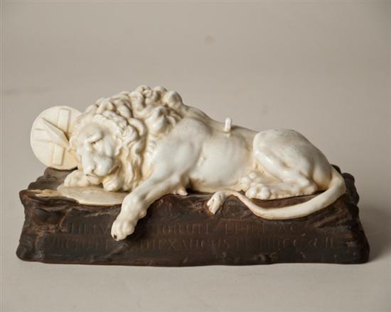 Appraisal: A Continental Porcelain Recumbent Lion killed by spear on rectilinear