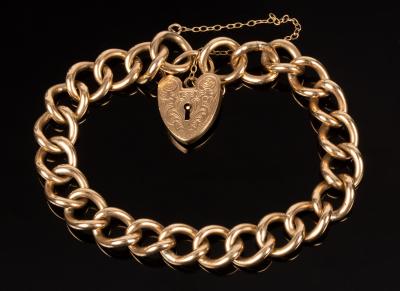 Appraisal: A ct gold curb link bracelet S K with heart-shaped