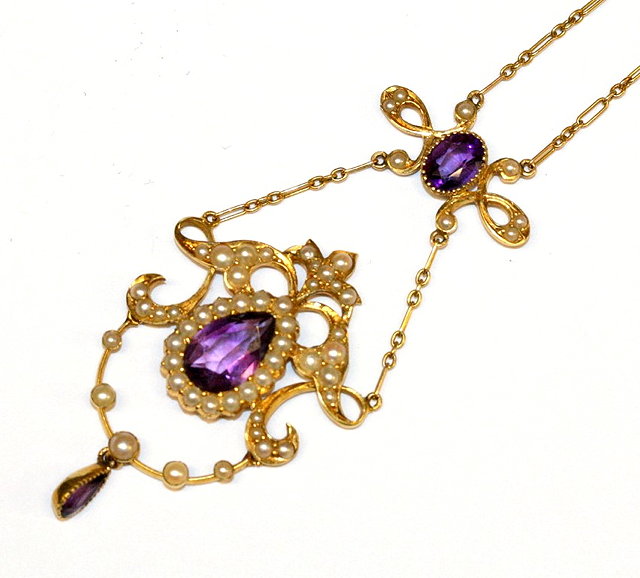 Appraisal: AN EDWARDIAN AMETHYST AND PEARL PENDANT AND CHAIN a pear