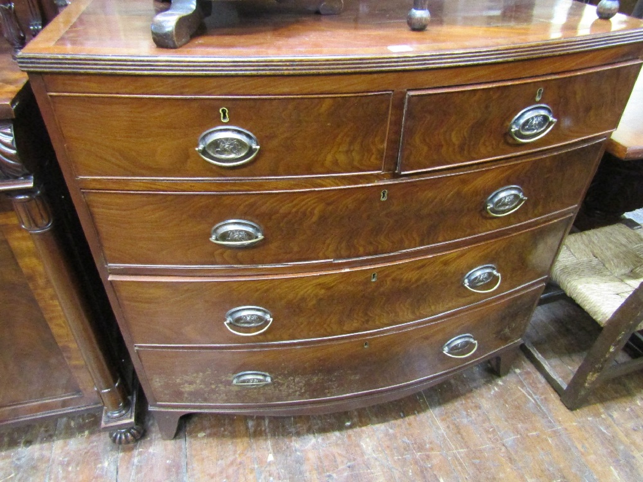 Appraisal: A mid- th century bow fronted chest of three long