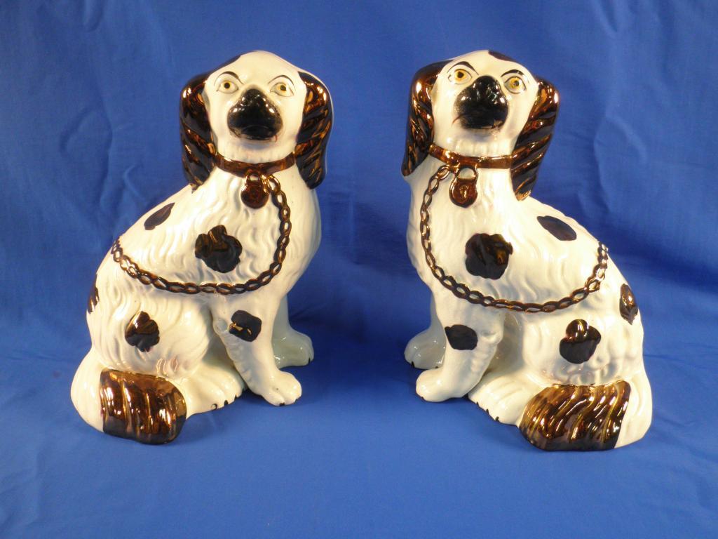 Appraisal: A pair of late thC Staffordshire Spaniels each with copper