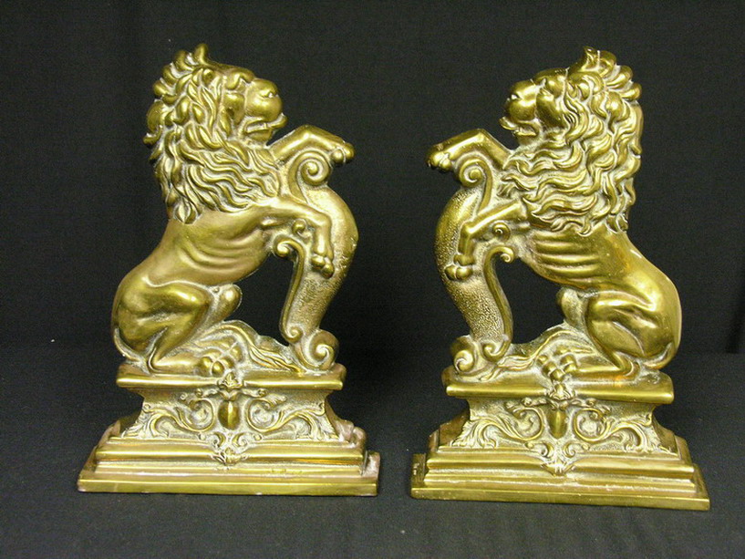 Appraisal: HEAVY CAST BRASS REARING LION AND IRONS Size by