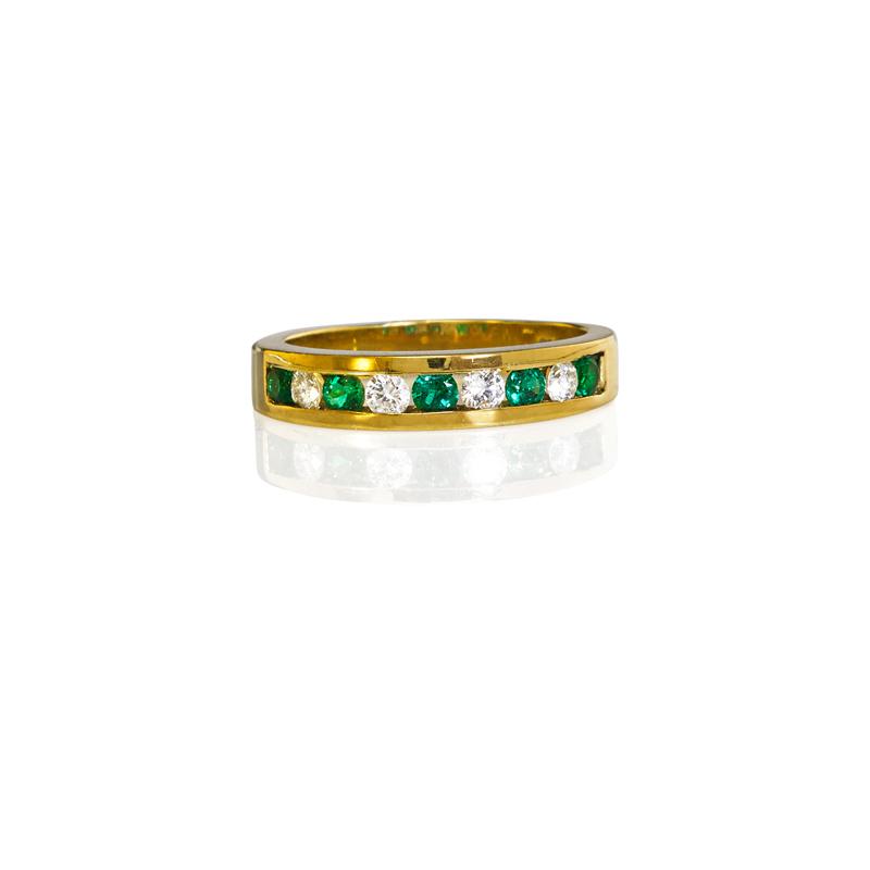 Appraisal: TIFFANY CO DIAMOND AND EMERALD K GOLD BAND Half-hoop channel