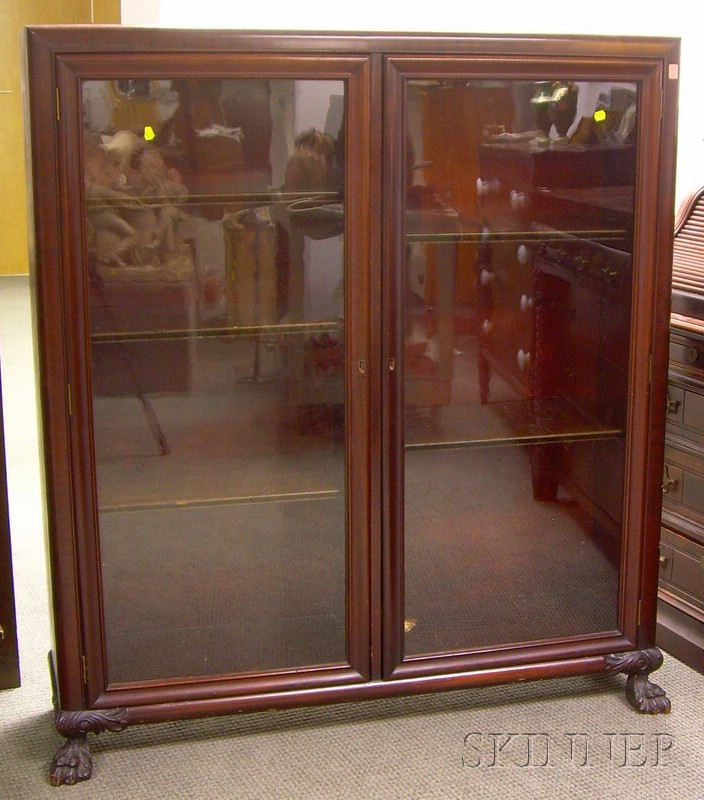 Appraisal: Empire-style Mahogany and Mahogany Veneer Two-Door Book Cabinet divided interior