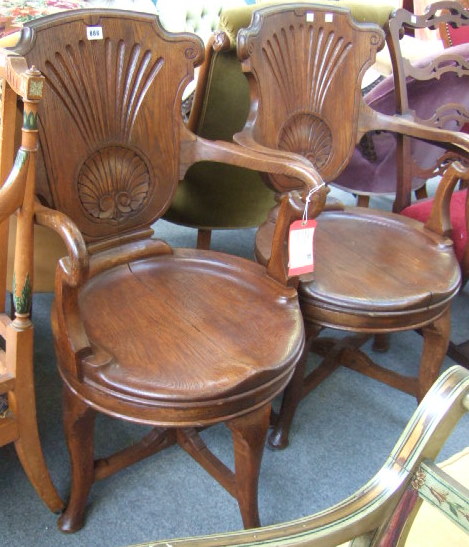 Appraisal: A pair of mid th century design oak swivel chairs