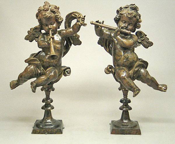 Appraisal: A pair of Baroque style patinated bronze figures of putti