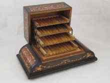 Appraisal: A veneer inlaid musical cigarette box the cigarettes displayed on