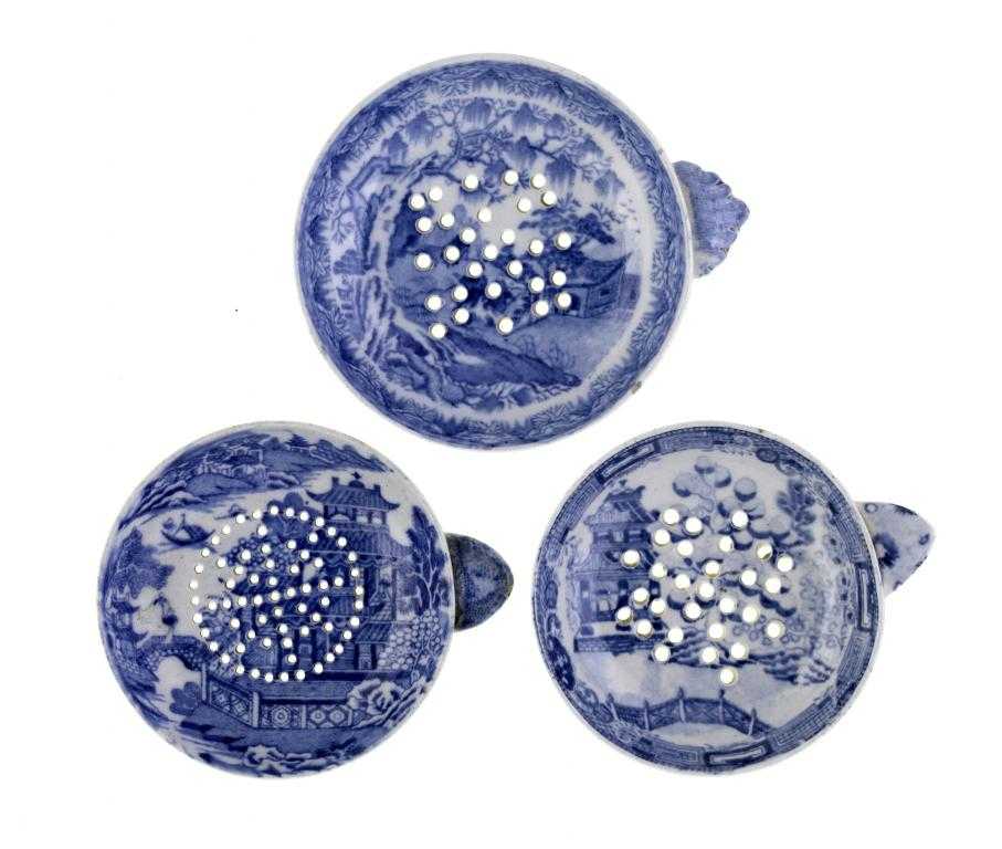 Appraisal: THREE BLUE PRINTED EARTHENWARE EGG DRAINERS Willow and similar patterns