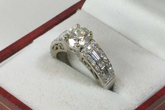 Appraisal: DIAMOND AND EIGHTEEN KARAT WHITE GOLD RING centering a round